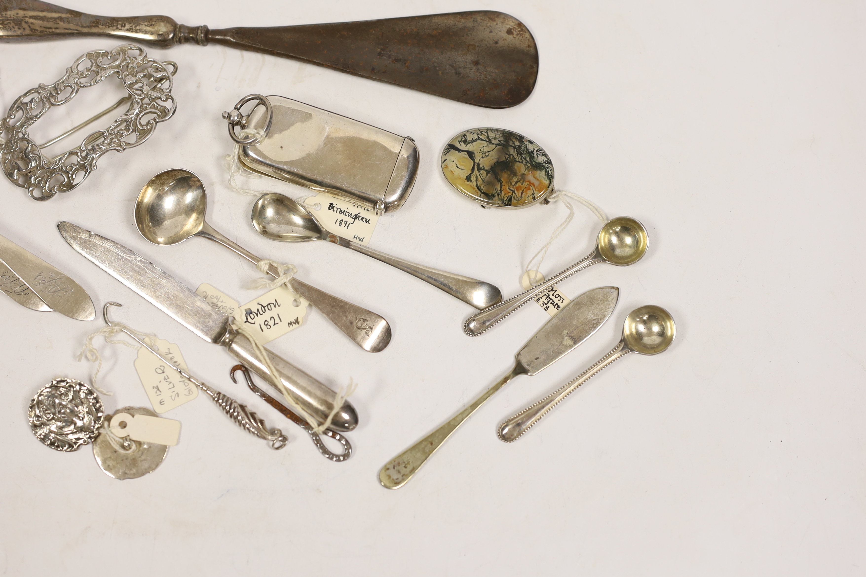 An Edwardian silver combination vesta and sovereign case (a.f.), seven small items of silver flatware, a pair of silver buttons and a silver clip, together with five other items including button hooks, a moss agate brooc